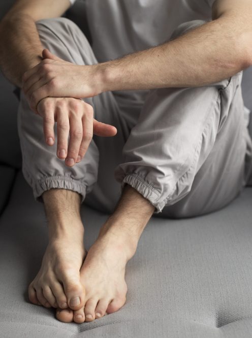high-angle-man-posing-while-sitting-down-couch