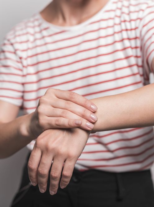 mid-section-young-woman-having-pain-wrist