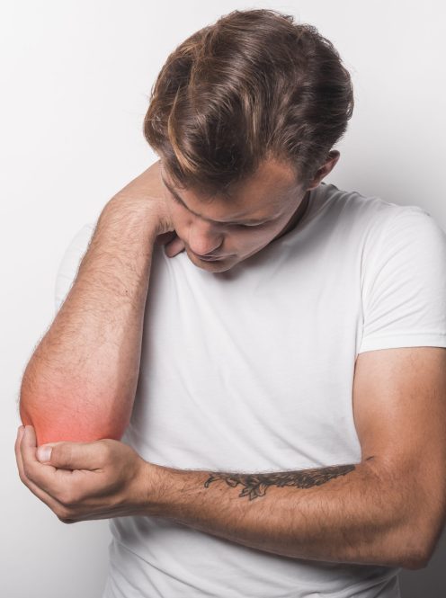young-man-having-elbow-injury-standing-against-white-background